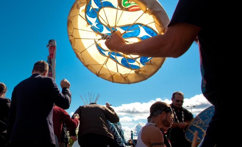 People marching together at an outdoor event under a blue sky